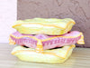 Stack of Pink and Yellow Ceramic Pillows