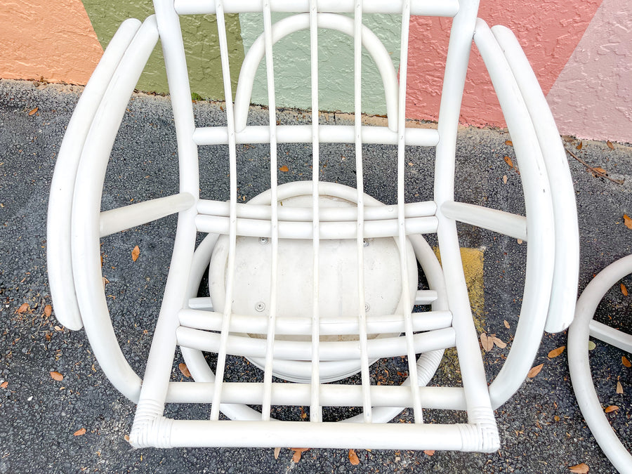 Pair of Rattan Swivel Chairs and Ottoman